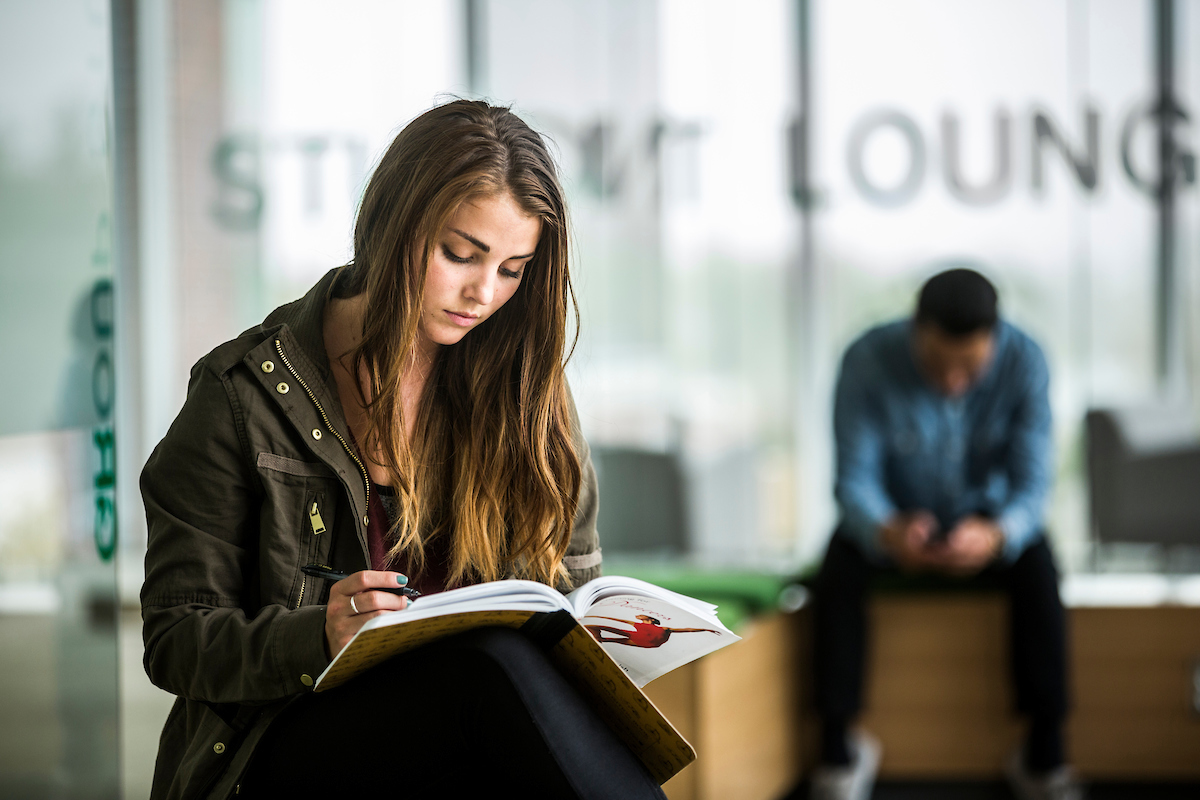 A student studying on campus