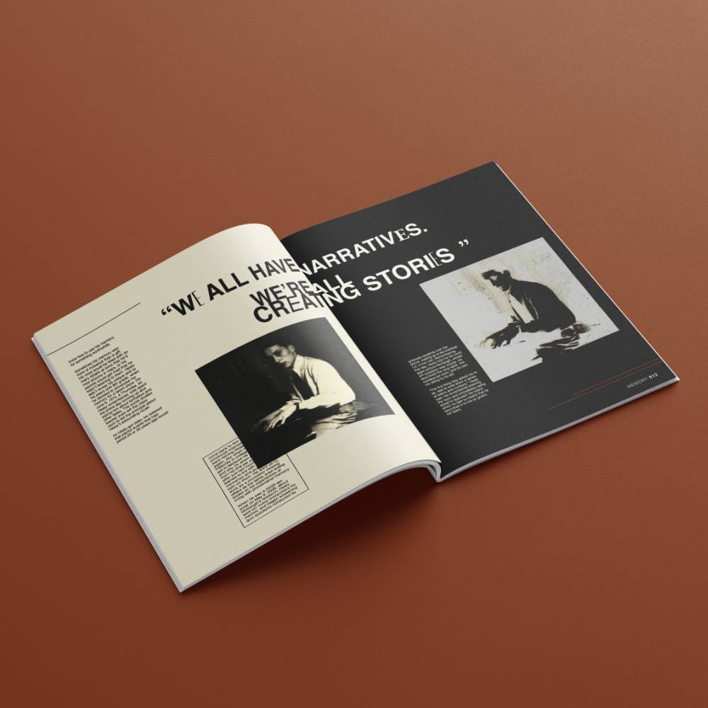 Open magazine showing text and monochrome photographs on a brown surface.              