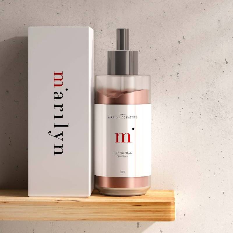 Cosmetic bottle and box with "marilyn" branding on a wooden shelf against a gray wall.              