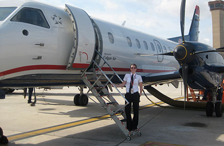 woman standing in front of a plane