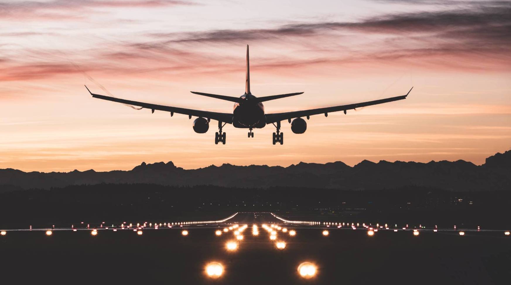 airliner landing at sunset