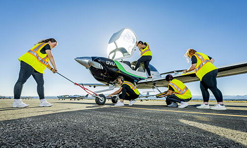 Students preping a plane for flight