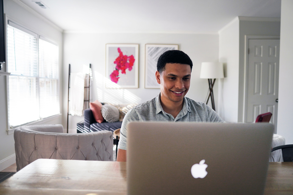 happy person working on laptop at home
