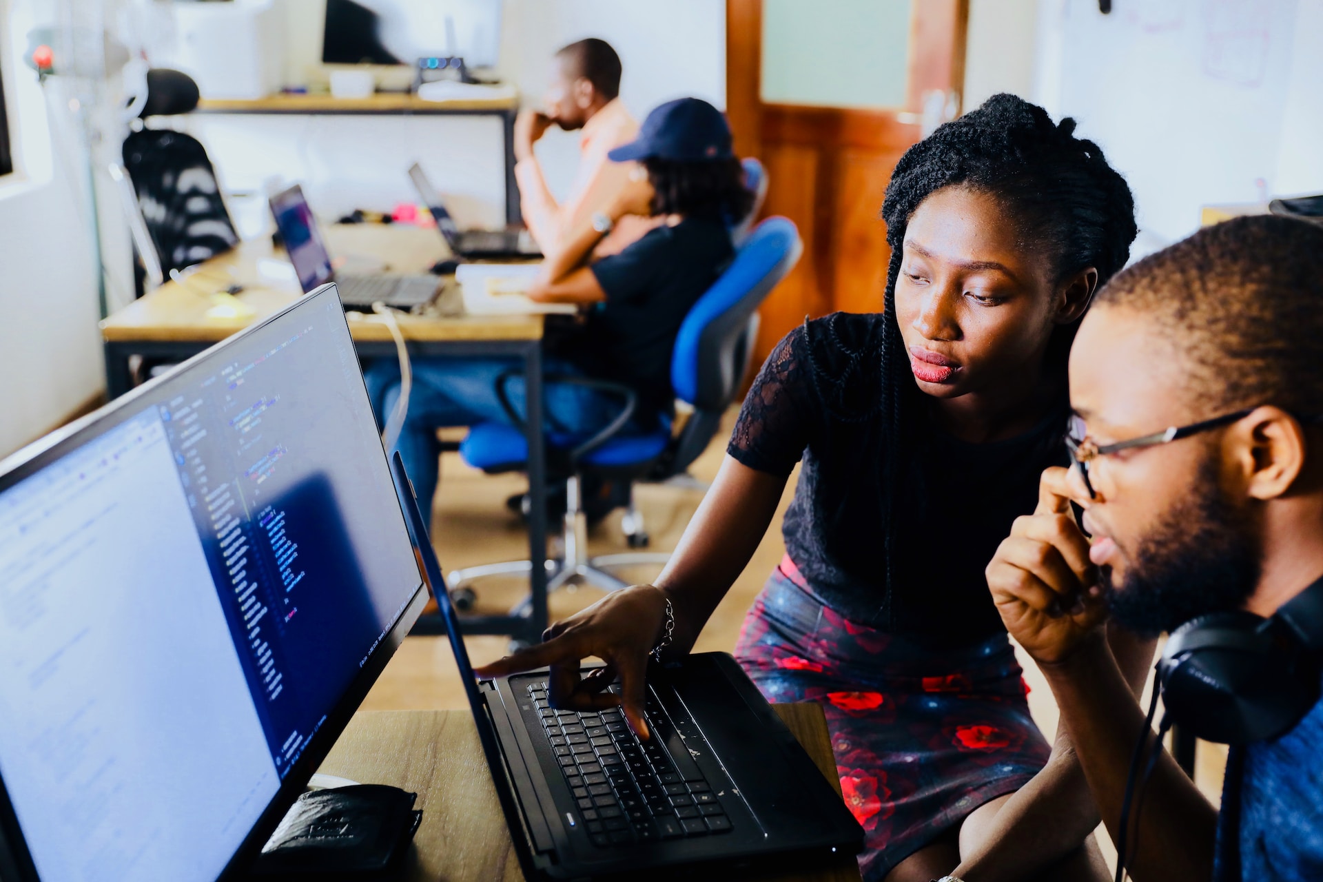 man and woman looking at a computer screen together