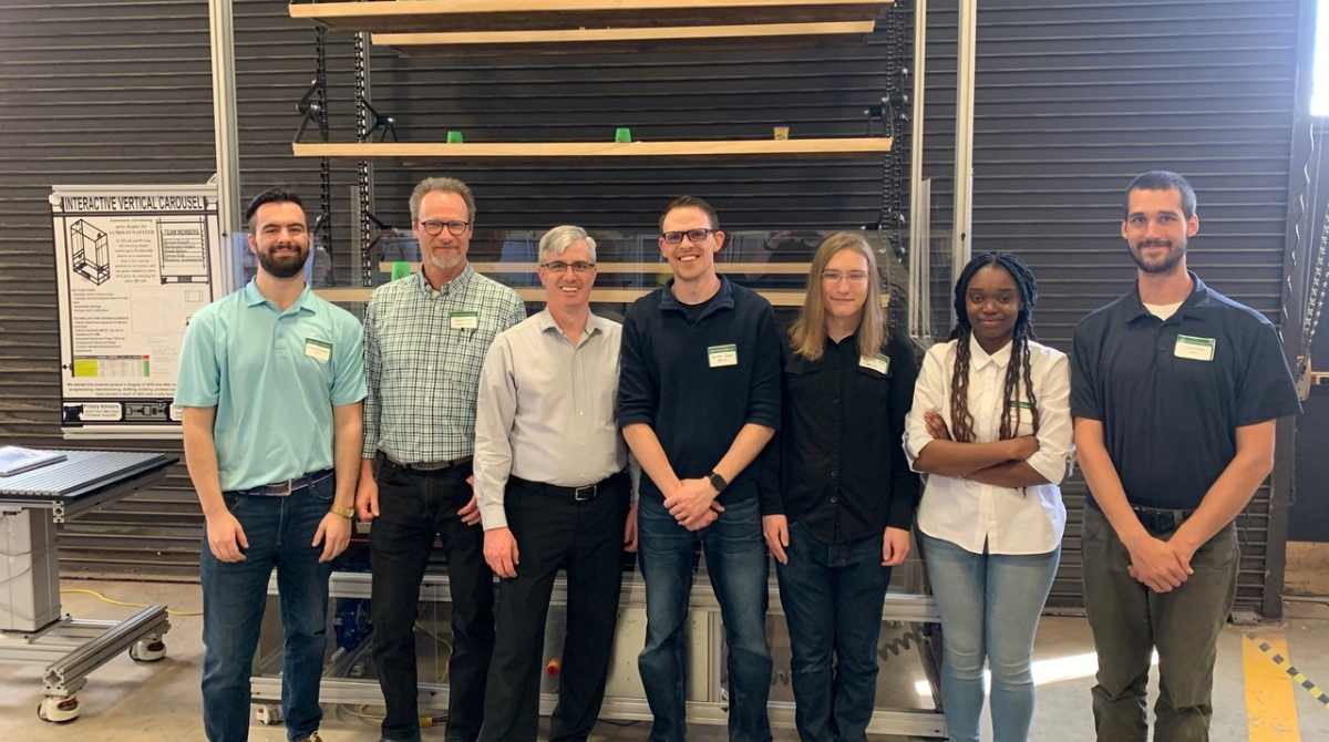 Students and teachears standing in a warehouse