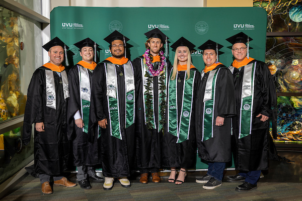 group of masters graduates in their robes