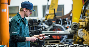 student working on car engine