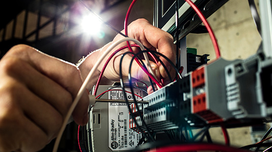 close up of hands working on wiring