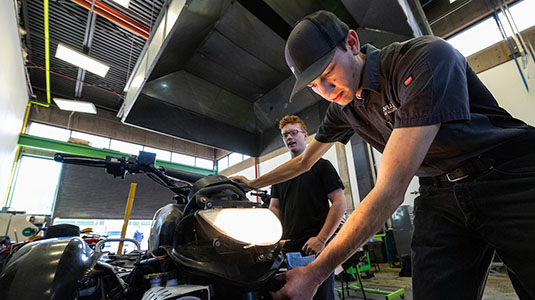 students working on a motorcycle