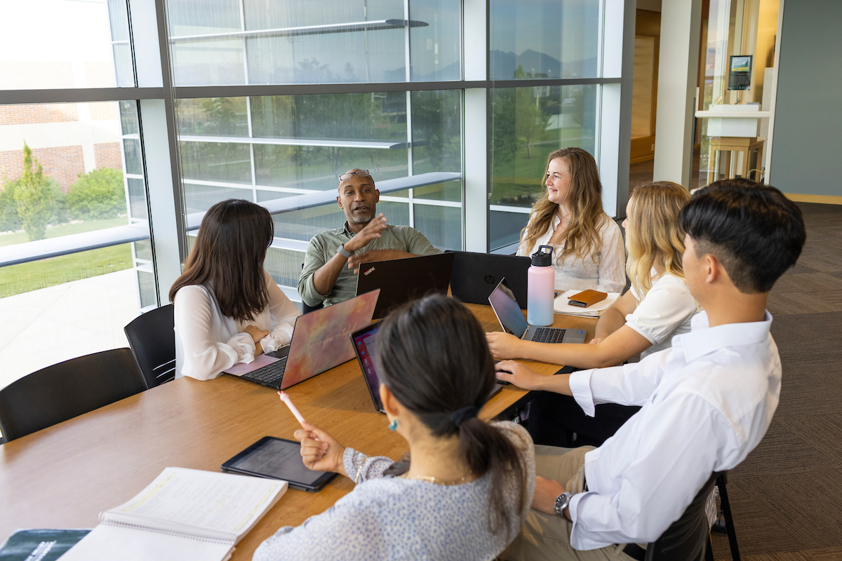 Staff sitting around a conference table in discussion.