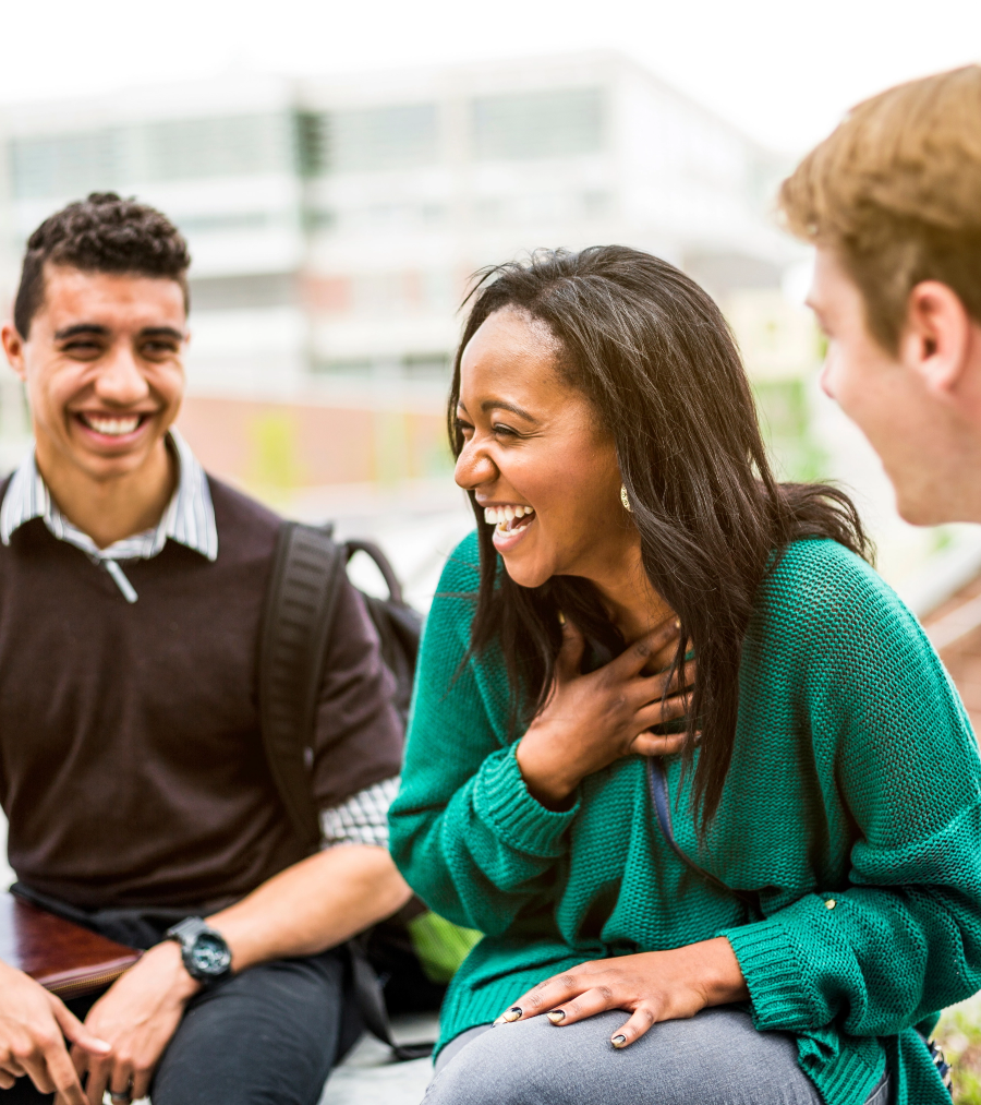 Three students sitting together in conversation.