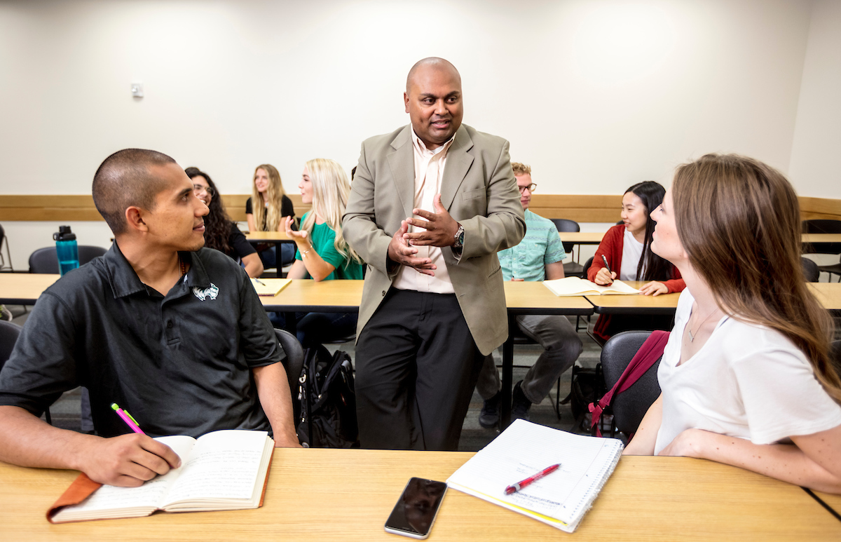 学生s and faculty in discussion in a lecture hall.