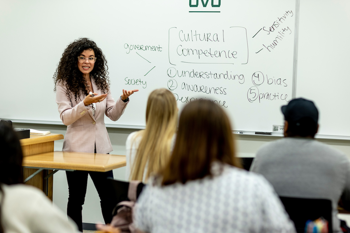 Female faculty member teaching in classroom.