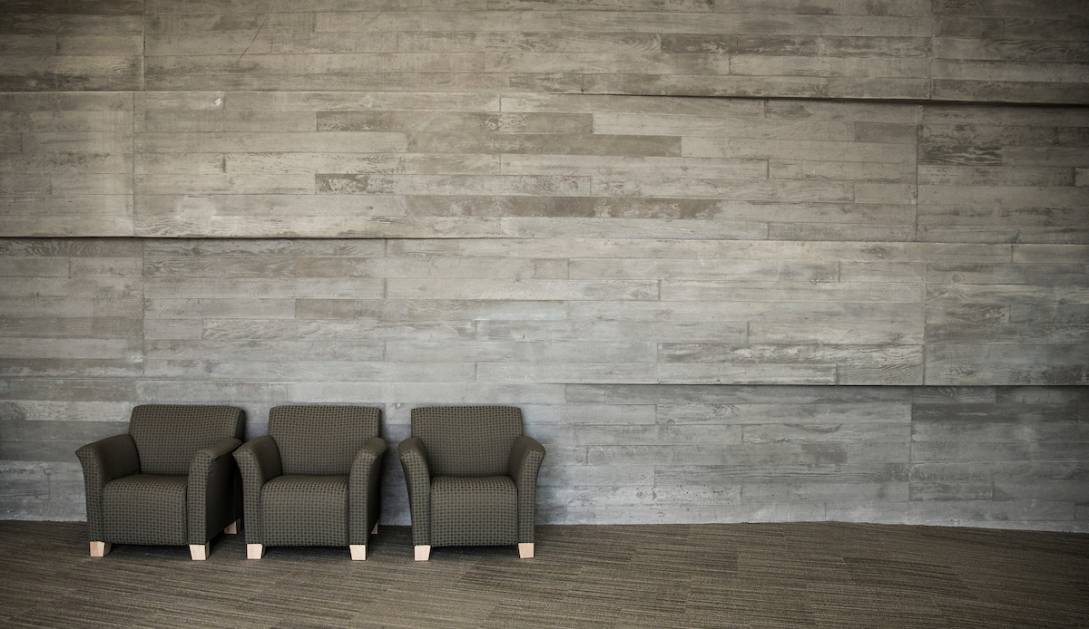 Photo of a wall and chairs on campus.