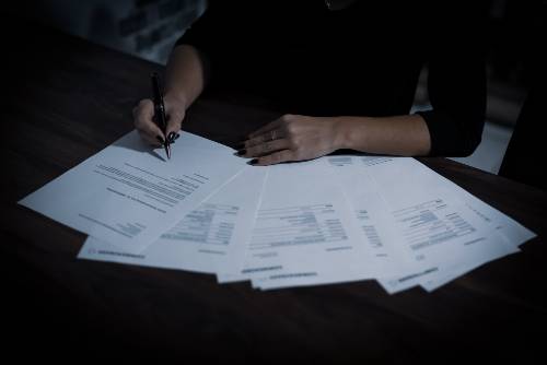 Individual reviewing and writing on documents