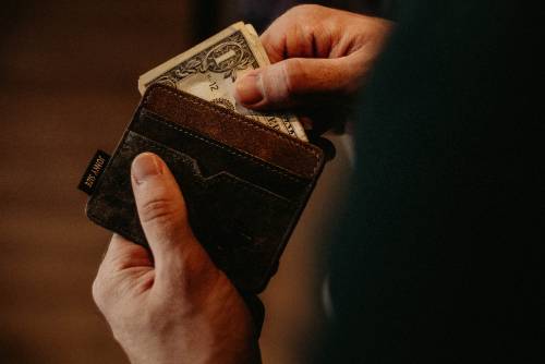 Hand taking cash out of a wallet