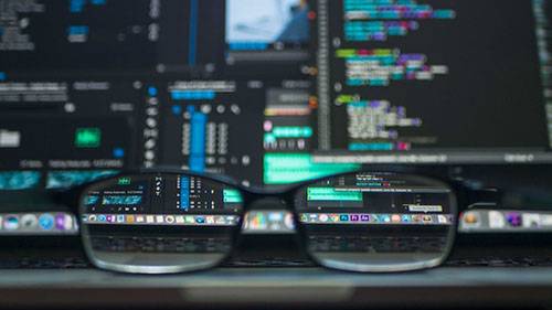 glasses sitting in front of a laptop screen