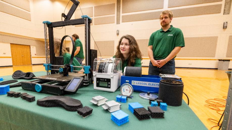 student working with mechanical arm