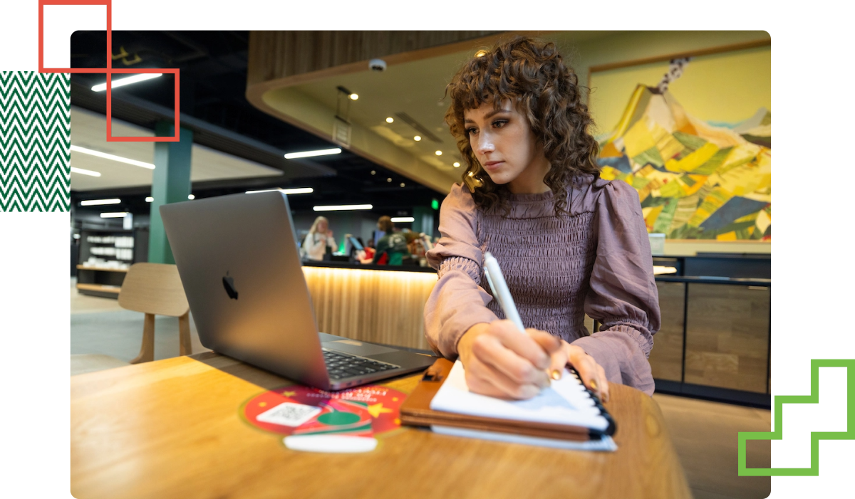 student sat at a desk with their laptop open in front of them