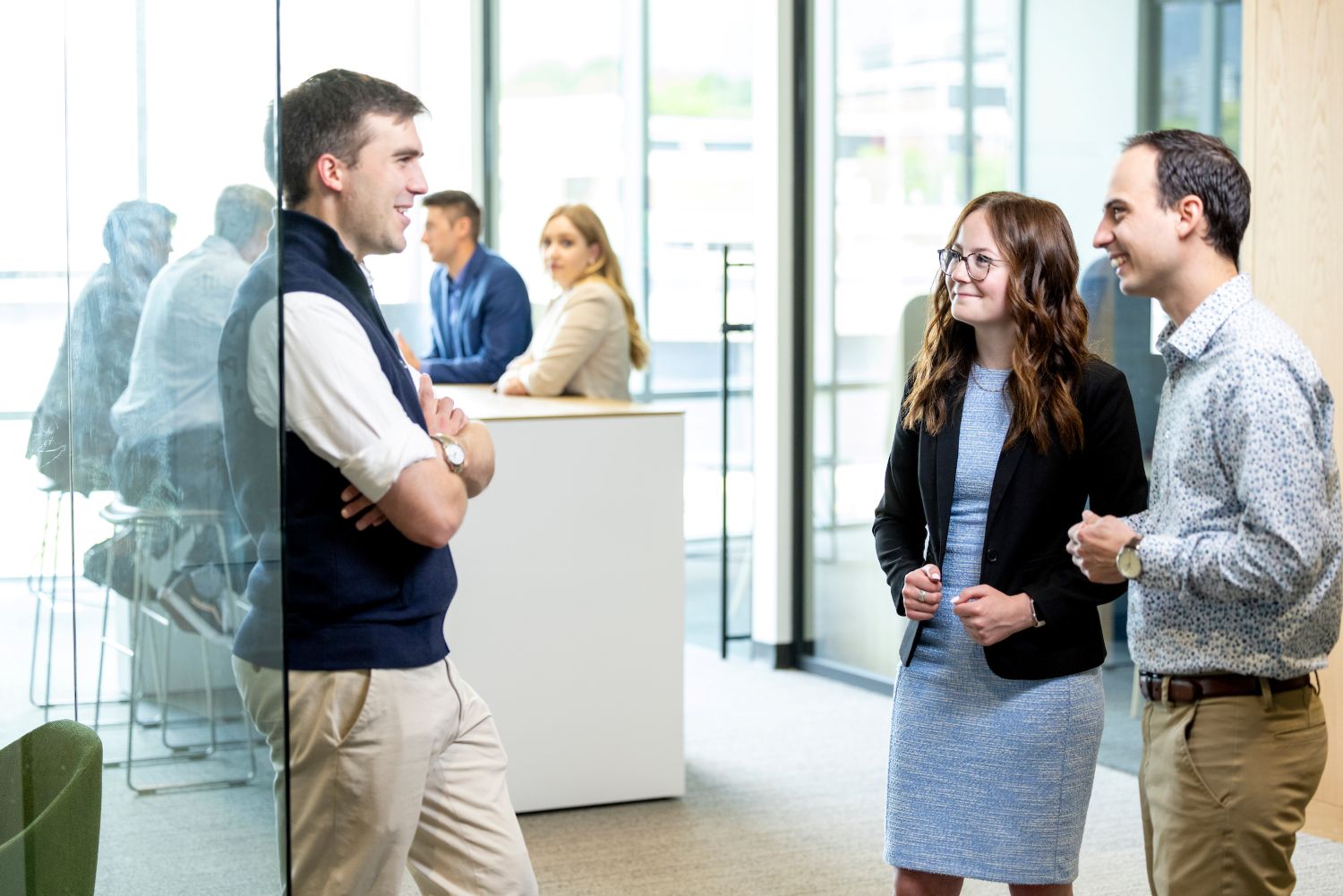 three people in an office setting having a conversation