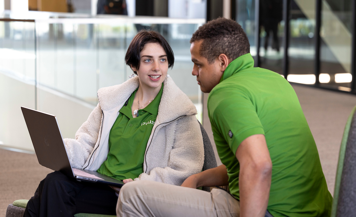 two people looking at a laptop