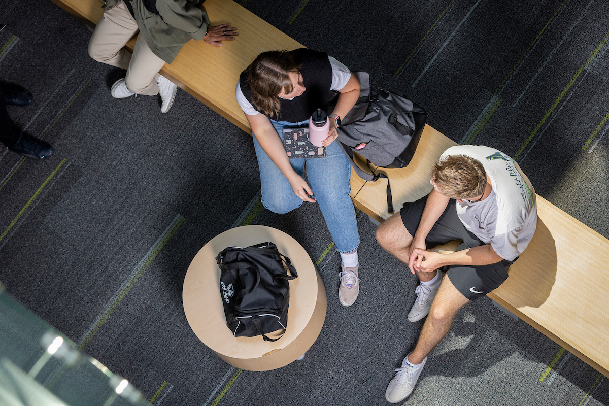 students sitting down having a conversation