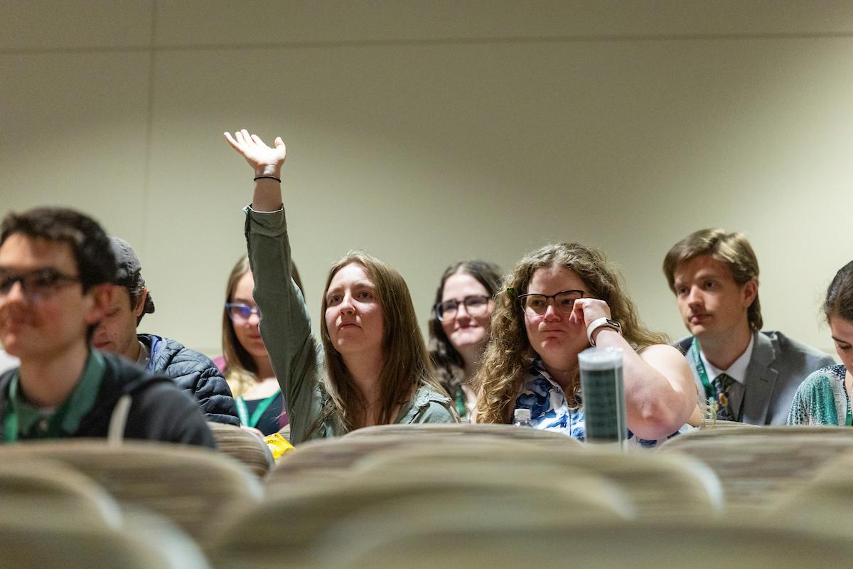 audience member raising their hand to ask a question