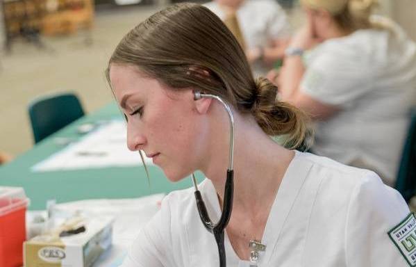 Nurse using tools at a booth