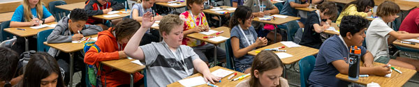 A UVU预科 student raising his hand in a class to ask a question