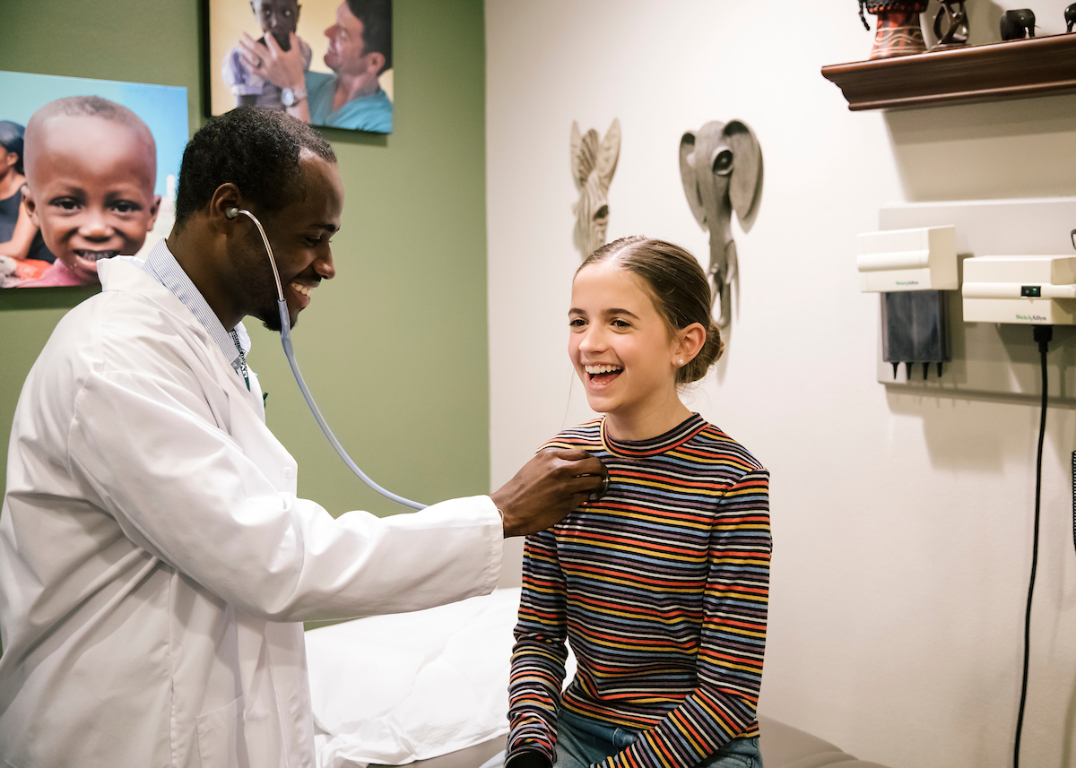 doctor checking a patient's heartbeat
