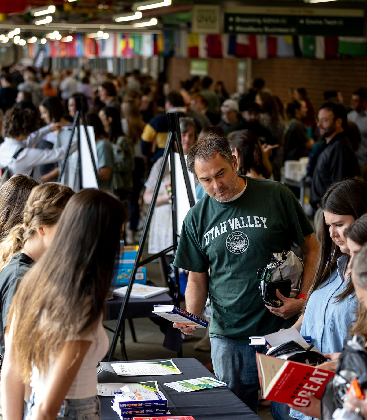Event in the hall of flags with people at a booth