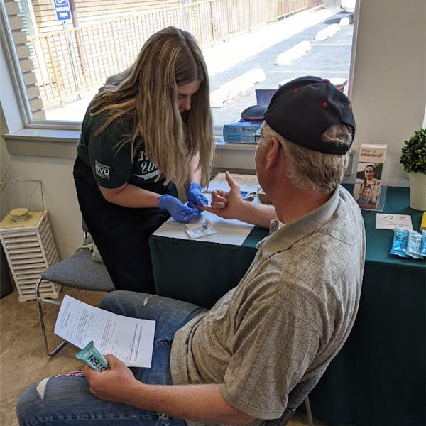 Person helping someone in public health