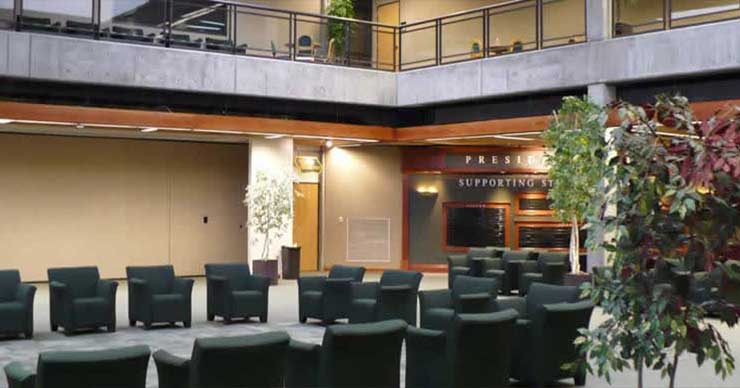 Shows the commons upper and lower floor.  Has seating in lower level and tables and chairs for studying in upper level.