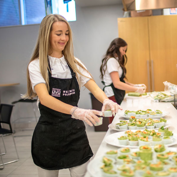 Wellness interns preparing and serving a nutritious recipe