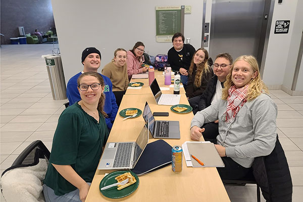 a group of people in the SC building at a desk